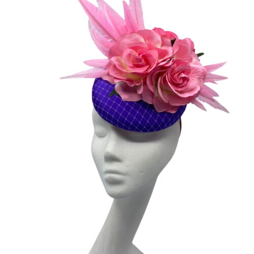 Stunning purple based headpiece with stunning candy pink flower and feather detail.